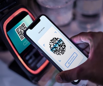 Two smartphones that read information with QR Code